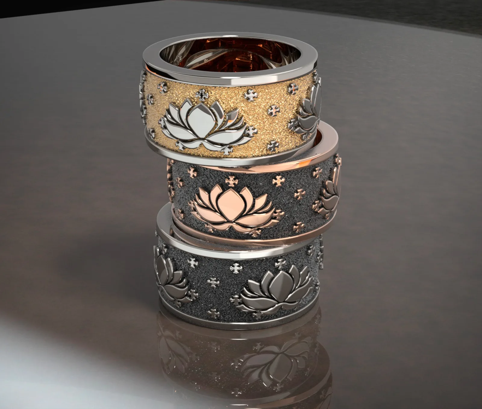 Three decorative wide rings with lotus motifs