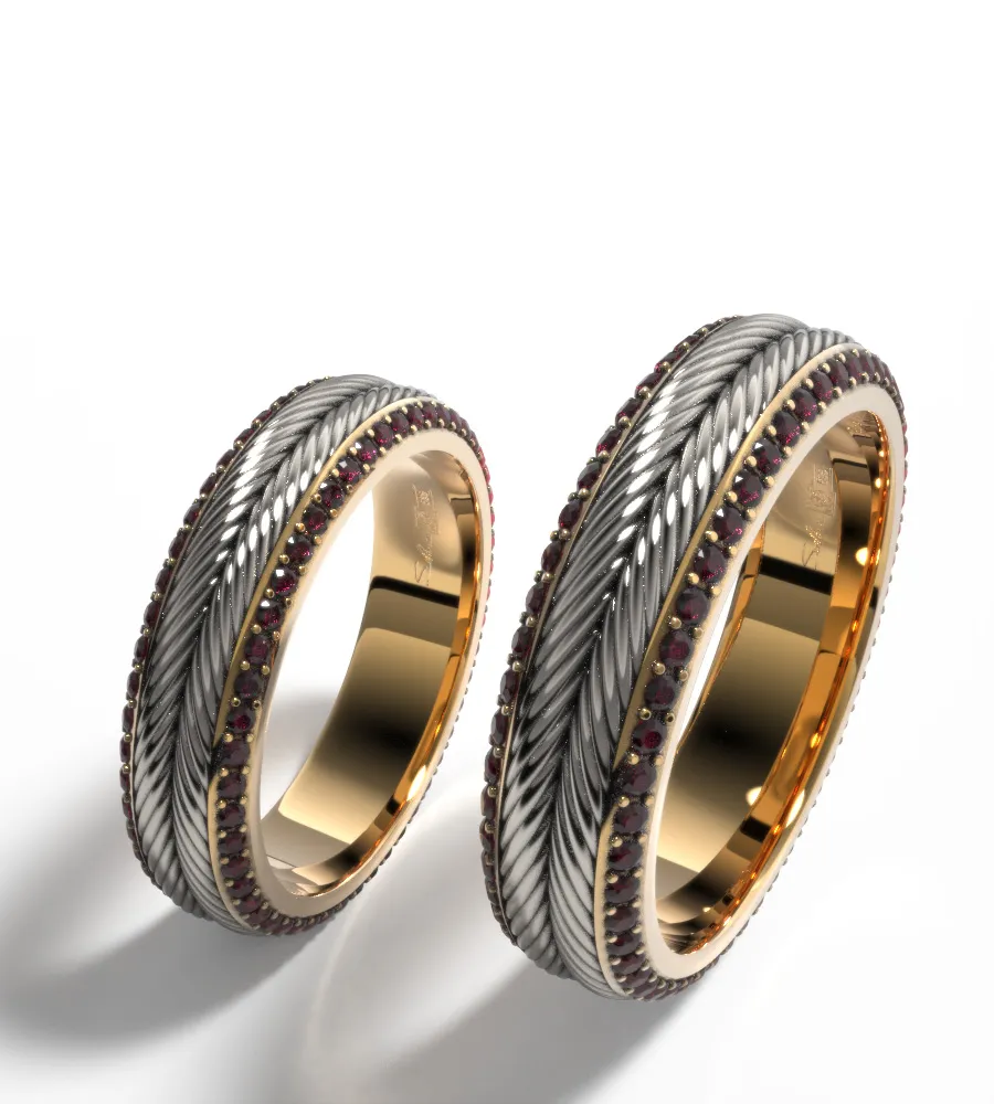 Pair of textured wedding bands on white background