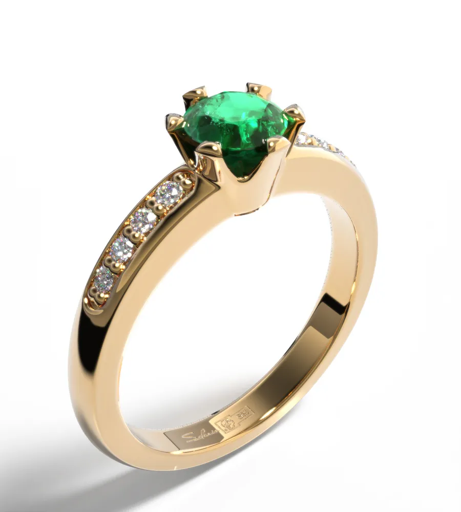 Yellow gold ring with green gemstone on white background